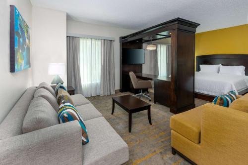 a hotel room with a couch and a bed at Hampton Inn and Suites Sarasota/Lakewood Ranch in Sarasota