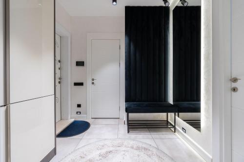 a bathroom with a mirror and a blue chair at Istanbul Apartment 01 in Tashkent