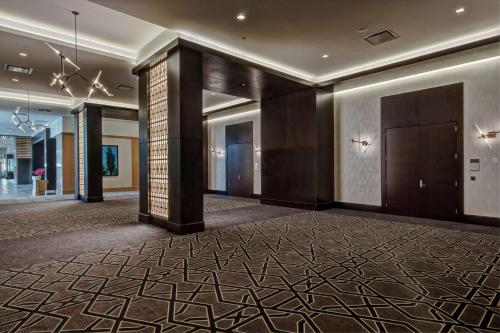 a lobby of a hotel with a large room with a hallway at Hilton Franklin Cool Springs in Franklin