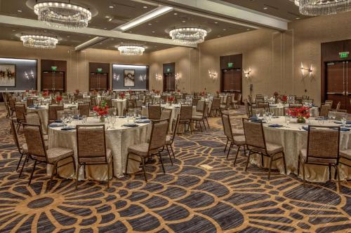 a banquet room with tables and chairs and chandeliers at Hilton Franklin Cool Springs in Franklin