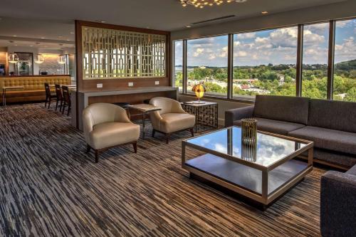 a living room with a couch and a table at Hilton Franklin Cool Springs in Franklin
