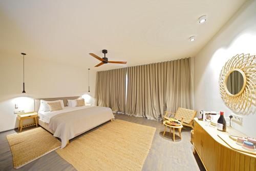 a bedroom with a bed and a ceiling fan at 7 Lakes in Tʼelavi