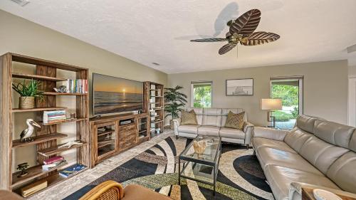 a living room with a couch and a ceiling fan at Gulf Birdie - 5551 in Siesta Key