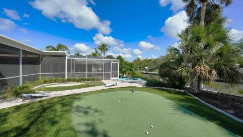 a golf course in front of a house at Gulf Birdie - 5551 in Siesta Key