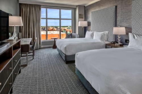 a hotel room with two beds and a large window at Hilton Nashville Green Hills in Nashville