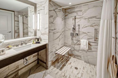 a bathroom with a sink and a shower at Hilton Nashville Green Hills in Nashville