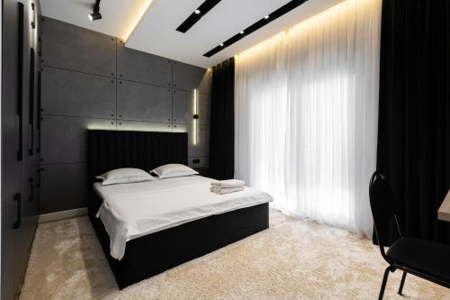 a bedroom with a bed and a large window at Istanbul Apartment 01 in Tashkent