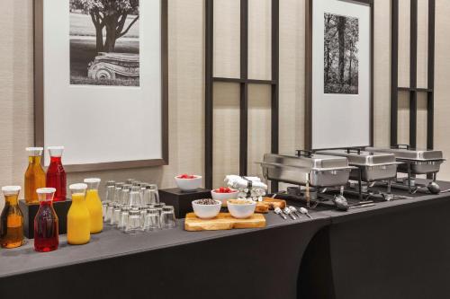 a counter with a buffet of food and drinks at Home2 Suites By Hilton Nashville West End Avenue in Nashville