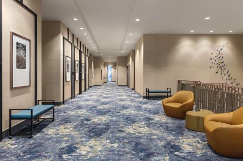 a hallway with couches and chairs in a building at Home2 Suites By Hilton Nashville West End Avenue in Nashville