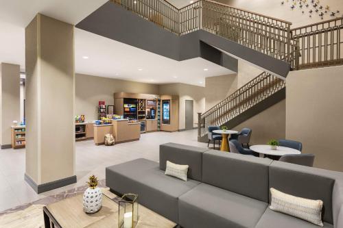 a lobby with a couch and a staircase at Hilton Garden Inn Nashville West End Avenue in Nashville