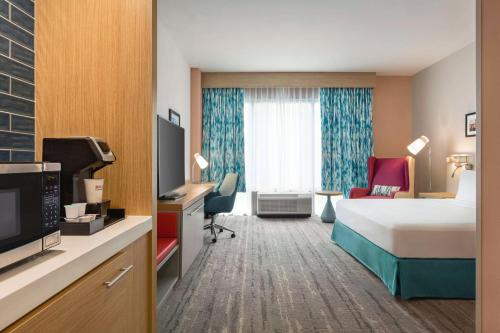 a hotel room with a bed and a television at Hilton Garden Inn Nashville West End Avenue in Nashville