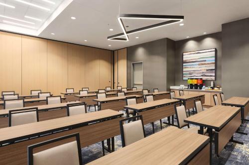 an empty classroom with tables and chairs and a screen at Hilton Garden Inn Nashville West End Avenue in Nashville