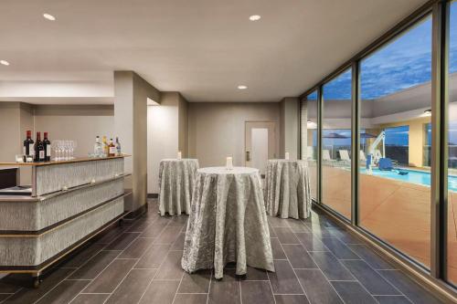 a dining room with a table and a pool at Hilton Garden Inn Nashville West End Avenue in Nashville