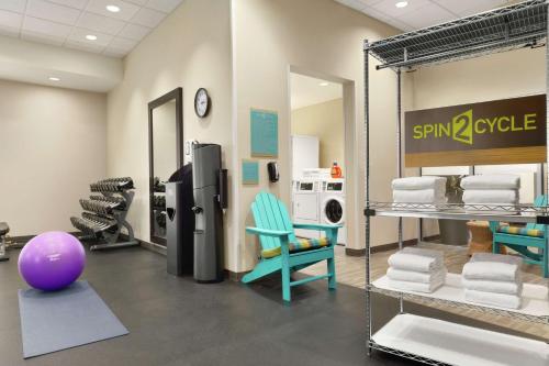 a laundry room with a refrigerator and a purple ball at Home2 Suites By Hilton Colorado Springs South, Co in Colorado Springs