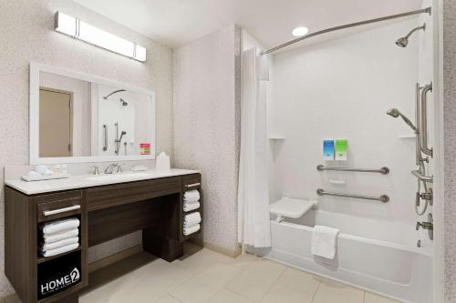 a bathroom with a sink and a tub and a shower at Home2 Suites By Hilton Colorado Springs South, Co in Colorado Springs