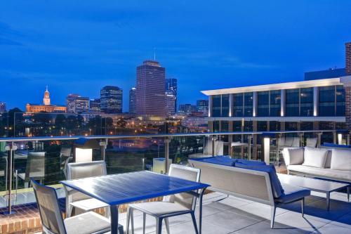 a balcony with a table and chairs and a city skyline at Hampton Inn & Suites Nashville Downtown Capitol View, Tn in Nashville