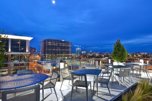 a balcony with tables and chairs and a city skyline at Hampton Inn & Suites Nashville Downtown Capitol View, Tn in Nashville
