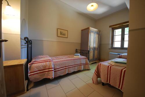 a bedroom with two beds and a window at Spoleto by the pool in Spoleto