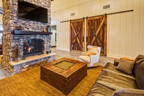 a living room with a fireplace and a couch at Black Fox Lodge Pigeon Forge, Tapestry Collection by Hilton in Pigeon Forge