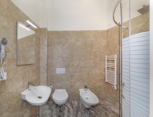a bathroom with a sink and a toilet and a mirror at Cristallo Park Hotel in Portovenere