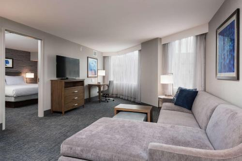 a hotel room with a couch and a bed at Homewood Suites By Hilton Ottawa Downtown in Ottawa