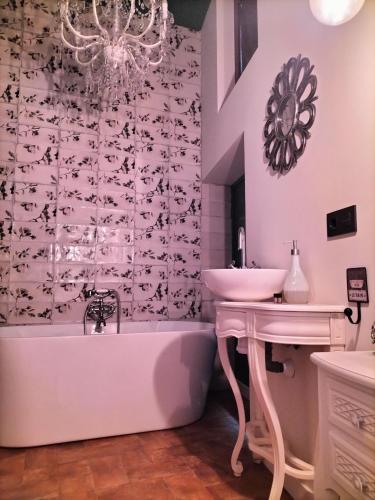 a bathroom with a sink and a bath tub and a sink at La Mirada de Amelia in Tabera de Abajo