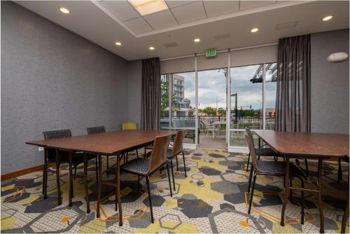 a conference room with two tables and chairs and a balcony at Homewood Suites By Hilton Edina Minneapolis in Edina