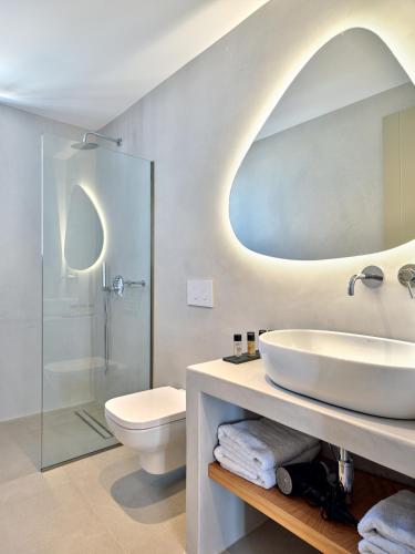 a bathroom with a sink and a mirror at Paros Gem in Naousa