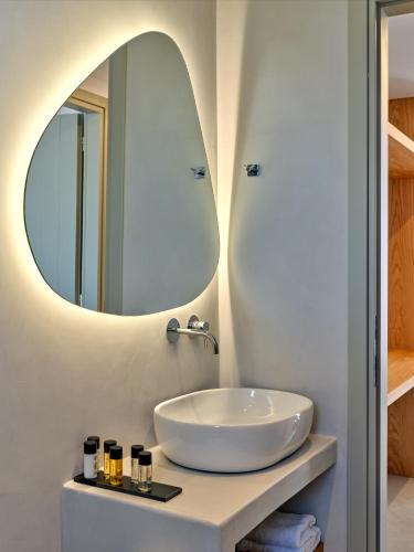 a bathroom with a sink and a mirror at Paros Gem in Naousa