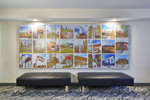 a large painting on a wall with a couch in a room at Doubletree By Hilton Atlanta Perimeter Dunwoody in Atlanta