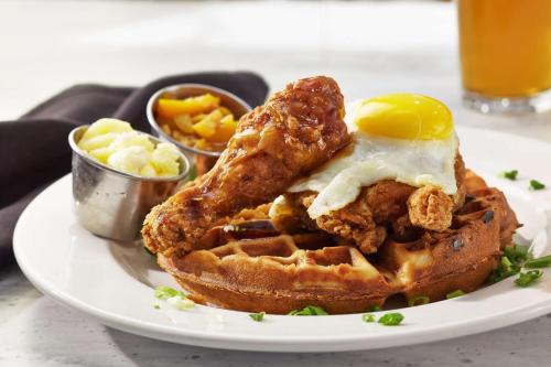 a plate of food with a fried egg and waffles at Doubletree By Hilton Atlanta Perimeter Dunwoody in Atlanta