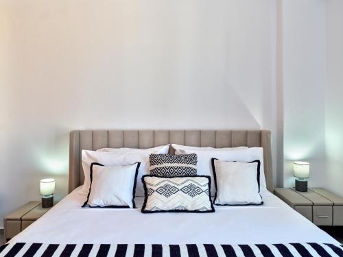a bedroom with a large bed with pillows at Paros Gem in Naousa