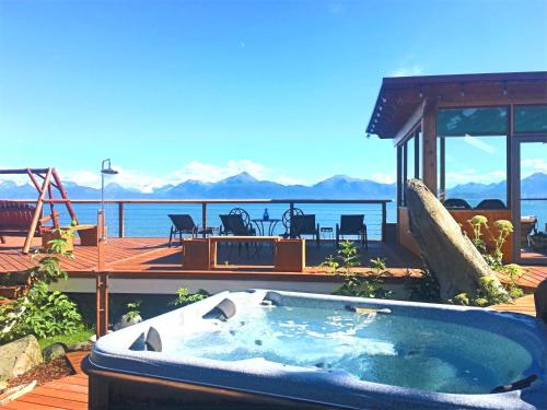 a hot tub on a deck with a view of the water at Homer Inn & Spa in Homer