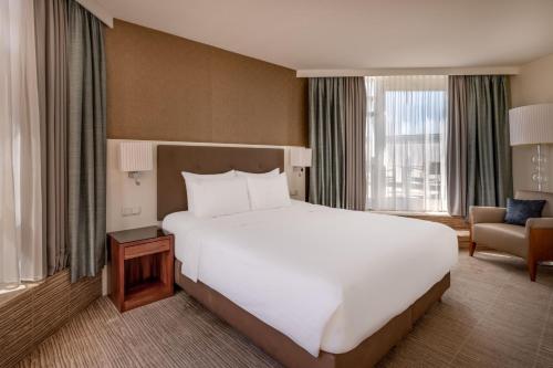 a large white bed in a hotel room at Munich Marriott Hotel in Munich