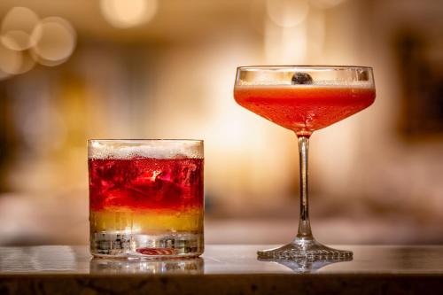 two cocktails sitting next to each other on a table at Munich Marriott Hotel in Munich