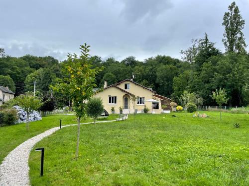 a house in a field with a gravel road at Maison aux pieds des Pyrénées - Piscine d'exception de 25m in Espoey