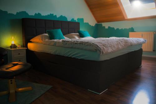 a bedroom with a large bed with green walls at KomfortZuhause in Wermelskirchen in Wermelskirchen