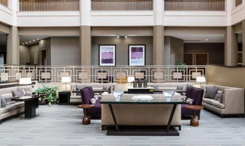 a lobby with couches and tables and chairs at Embassy Suites by Hilton Chicago North Shore Deerfield in Deerfield