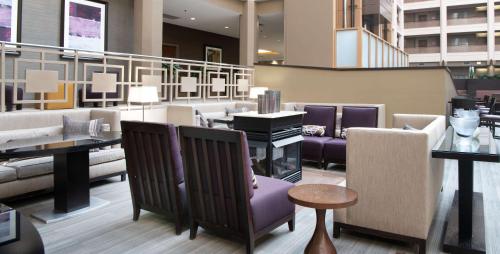 a lobby with chairs and tables in a building at Embassy Suites by Hilton Chicago North Shore Deerfield in Deerfield
