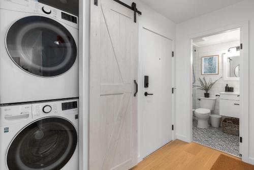 a white laundry room with a washer and dryer at Powderview 12 by Whistler Premier in Whistler