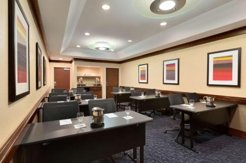a restaurant with tables and chairs in a room at Embassy Suites by Hilton Chicago North Shore Deerfield in Deerfield