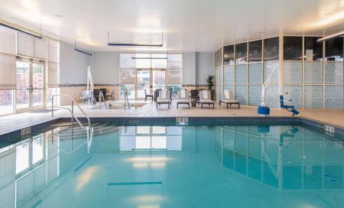 a swimming pool with blue water in a building at Hilton Columbus/Polaris in Columbus