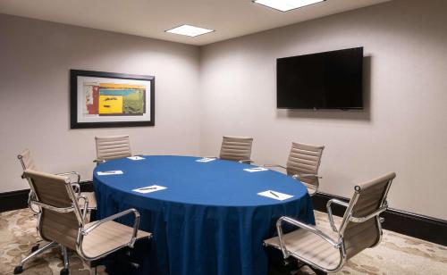 a conference room with a blue table and chairs at Hilton Columbus/Polaris in Columbus
