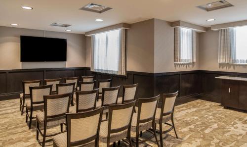 a conference room with a podium and a flat screen tv at Hilton Columbus/Polaris in Columbus