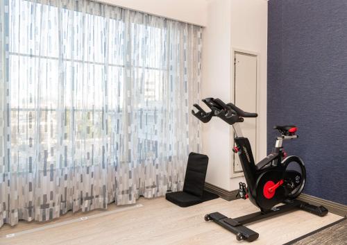 a room with a exercise bike in front of a window at Hilton Columbus/Polaris in Columbus