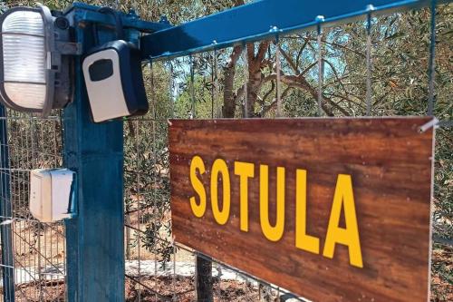 a sign that reads southila attached to a fence at Sotula in Érimos