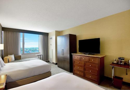 a hotel room with two beds and a flat screen tv at DoubleTree by Hilton Hotel & Suites Houston by the Galleria in Houston