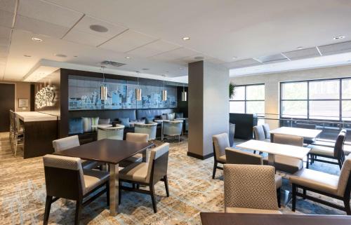a restaurant with tables and chairs and a bar at DoubleTree by Hilton Hotel & Suites Houston by the Galleria in Houston
