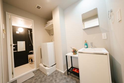 a small bathroom with a sink and a refrigerator at FL Residence The University of Tokyo II - Vacation STAY 12677 in Tokyo