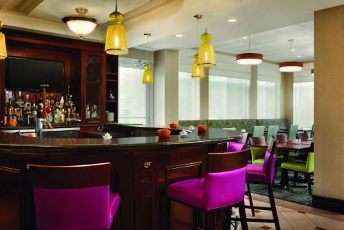 a bar with purple chairs in a restaurant at Hilton Garden Inn Niagara-on-the-Lake in Niagara on the Lake